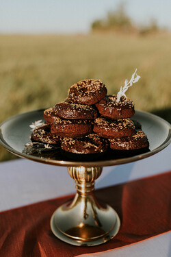 A plate of dessert doughnuts displayed on a gold display dish
