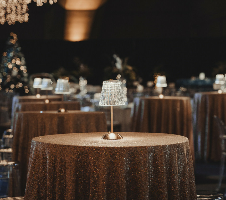 Cocktail tables with shimmery table linens and beautiful table lamps.