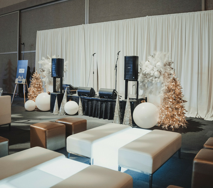 Audio Equipment setup at a company Christmas party with lounge seating sets in front of it.