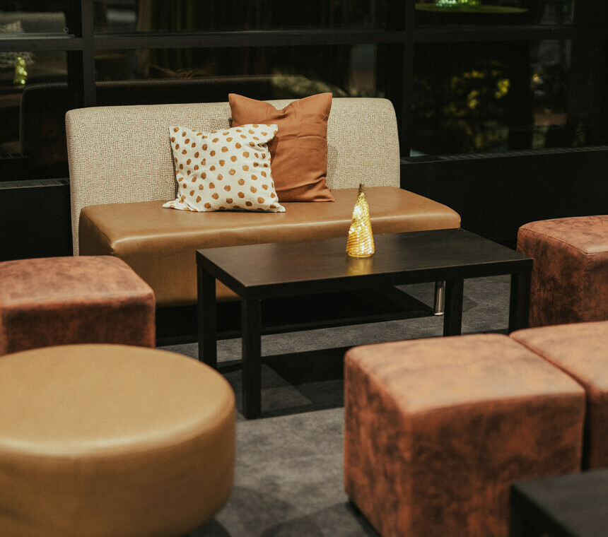 A set of lounge seating with a christmas tree decor on top of the table.