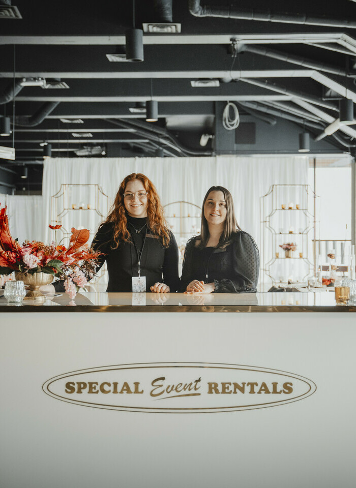 Special Event Rentals - Edmonton girls customer service staff helping customers at the desk