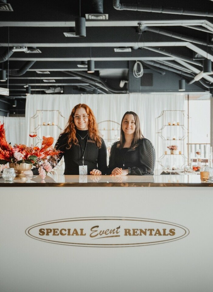 Special Event Rentals - Edmonton girls customer service staff helping customers at the desk