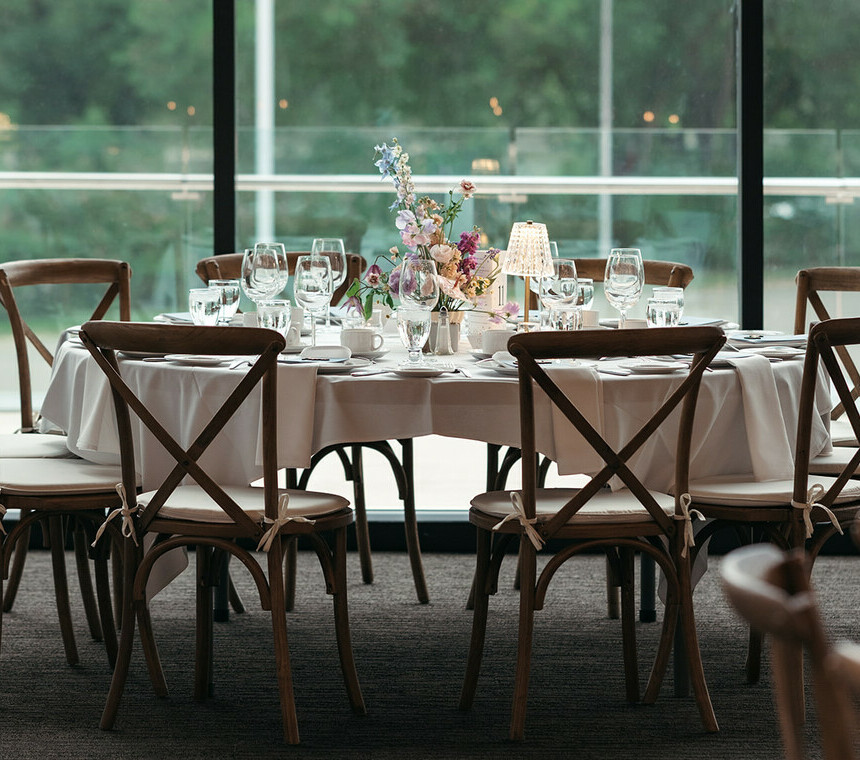 Vineyard Rustic Brown Wood Chairs in an indoor setting complete with table place settings