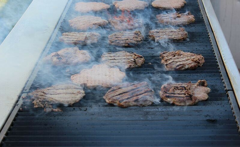 Special Event Rentals - Edmonton barbecue used to cook burger patties on its smoking grill