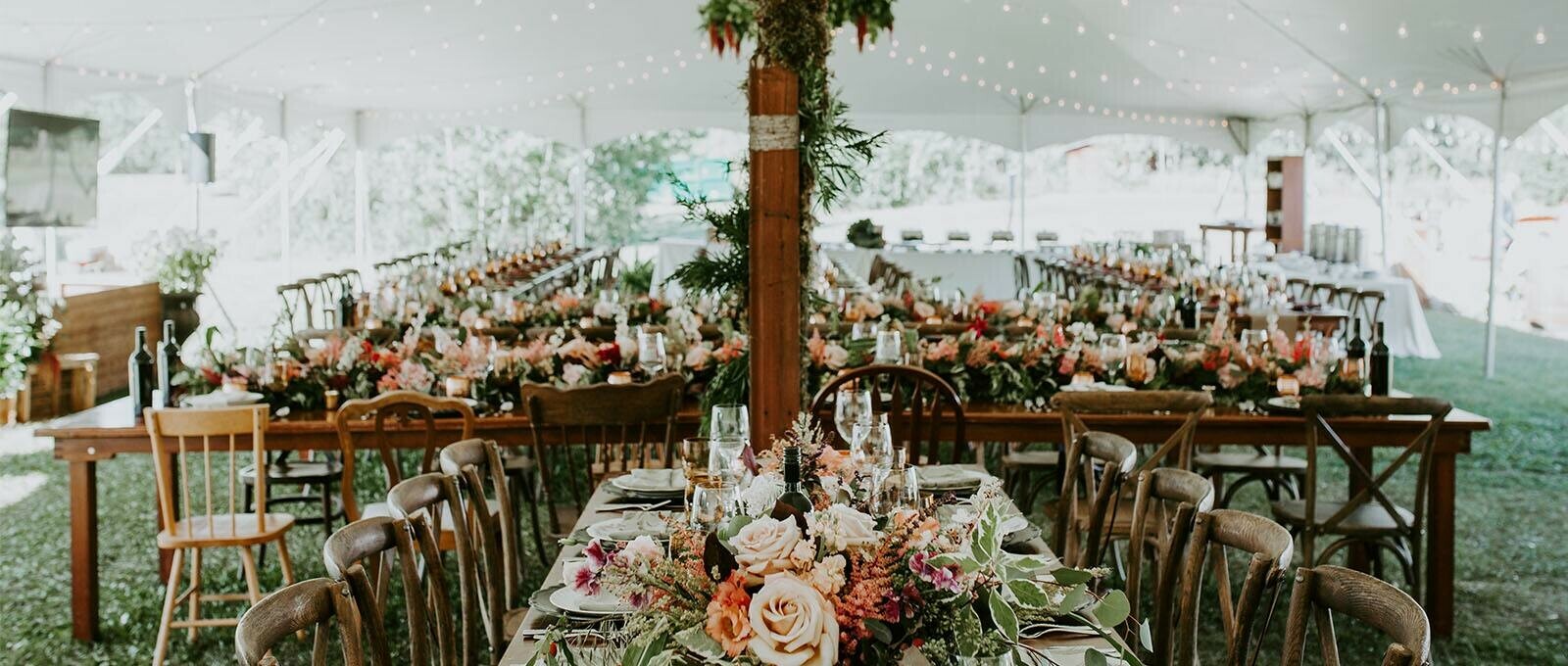 Special Event Rentals - Edmonton showcases vineyard chairs and tables, glassware, tableware, and tablecloths under a big pole tent